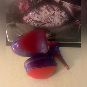 Worn one time on a boat ride. These purple patent leather red bottoms are sweet